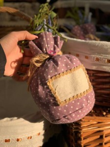 Lavender bag in female hands. Select goods in a flower shop. Aromatherapy.